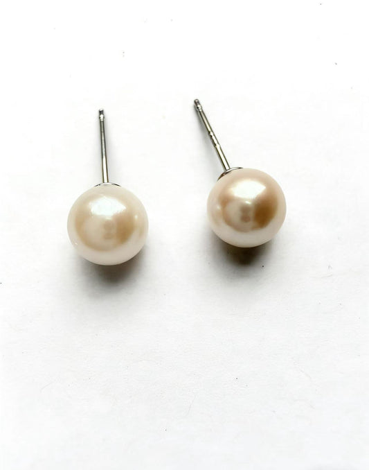 Two 6-7mm natural Hepu saltwater pearl stud earrings with soft luster and 925 sterling silver posts.