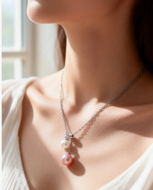 Double freshwater pearl pendant necklace with peach pink and white pearls on a sterling silver chain.