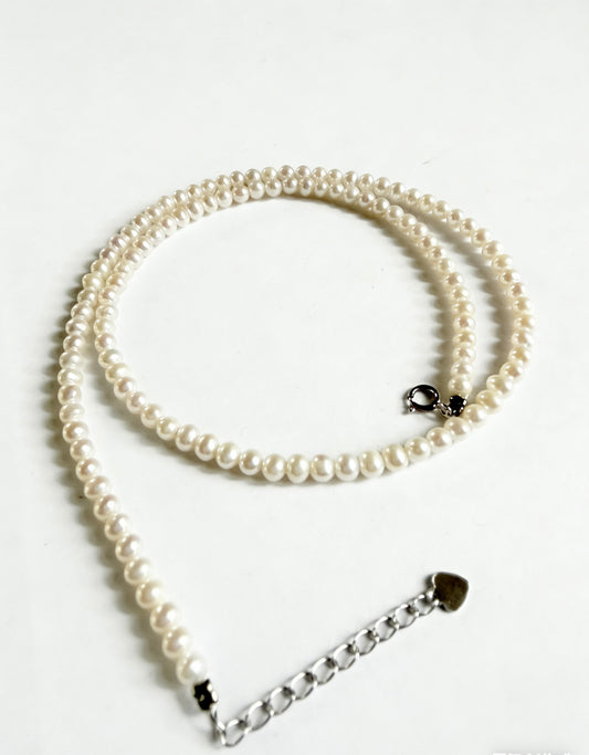 Minimalist 3-4mm near-round freshwater pearl choker with a 925 sterling silver clasp and extension chain.